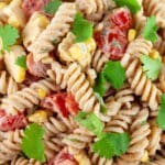 Southwest pasta salad garnished with cilantro in ceramic bowl.