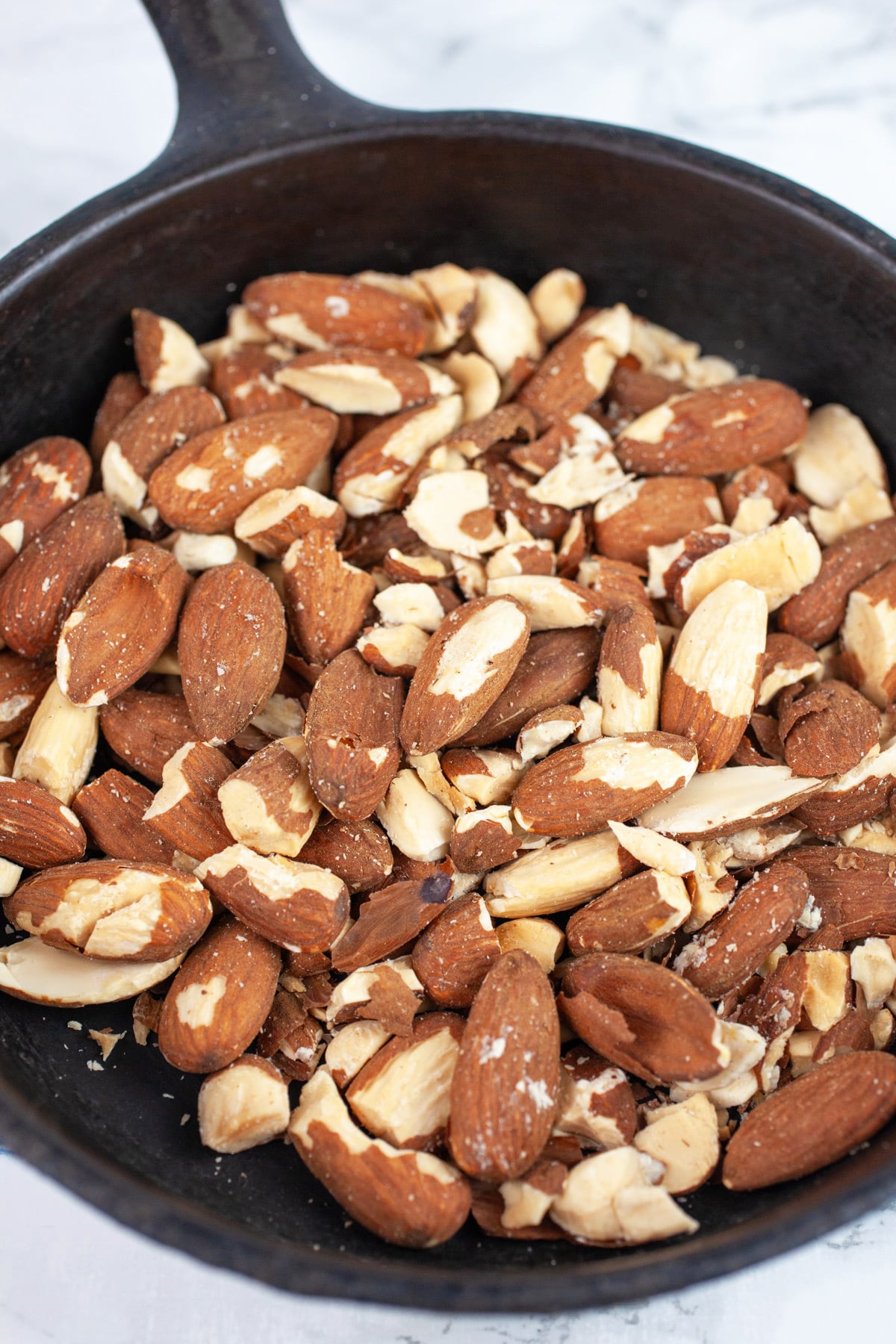 Toasted almonds in small cast iron skillet.