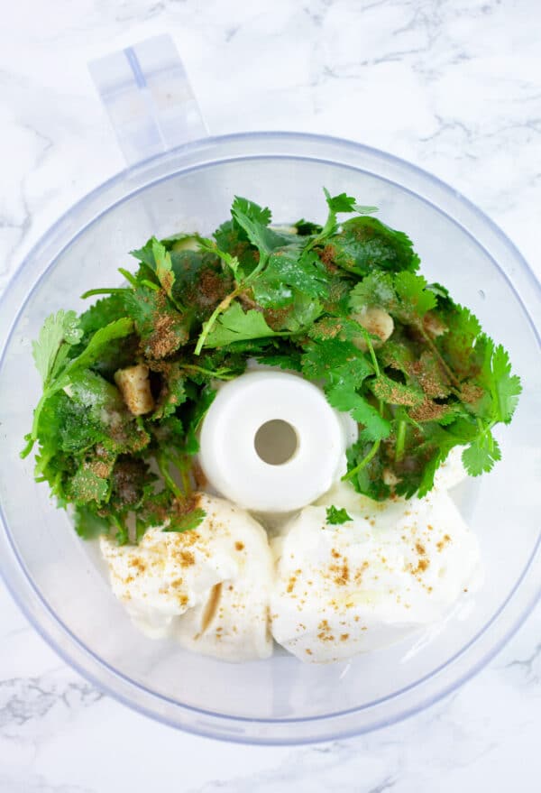 Sour cream, mayo, lime juice, honey, cumin, and fresh cilantro in food processor.