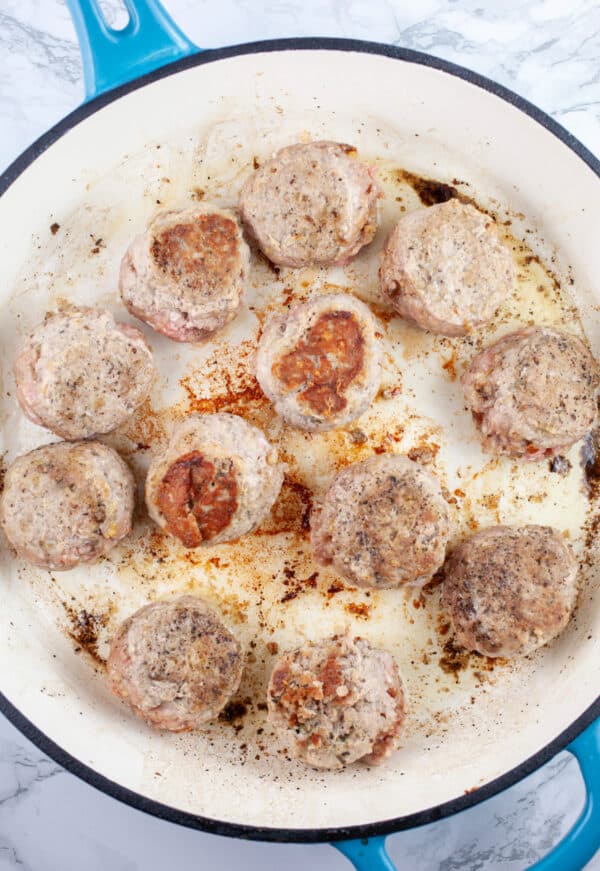 Ground turkey meatballs sauteed in skillet.