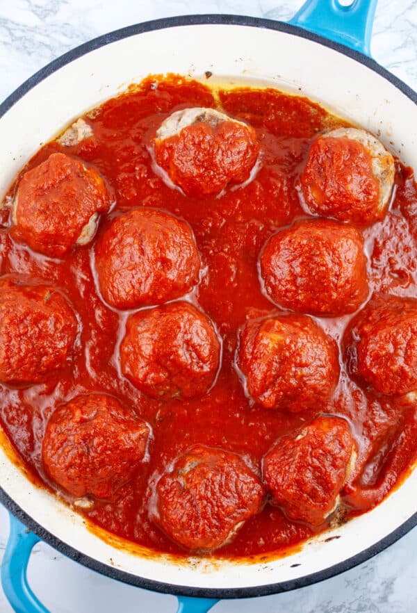 Turkey meatballs in marinara sauce in skillet.