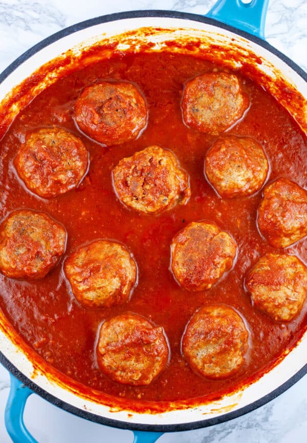 Turkey meatballs cooked in marinara sauce in skillet.