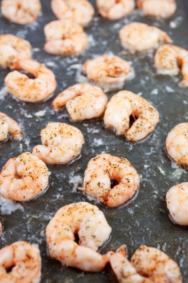 Cooked shrimp on baking sheet.