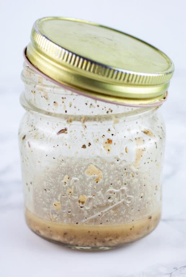 Red wine vinaigrette in small mason jar with lid.