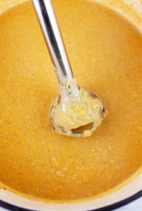 Corn cauliflower soup pureed with an immersion blender in Dutch oven.
