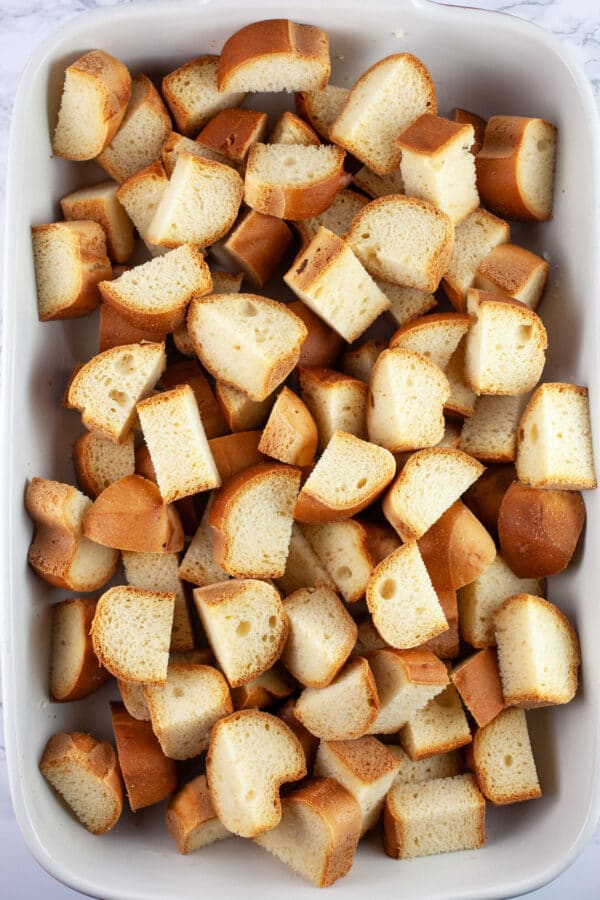 Brioche bread cubes in ceramic baking dish.