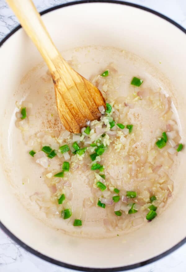 Minced garlic, onions, and jalapenos sauteed in Dutch oven with wooden spoon.