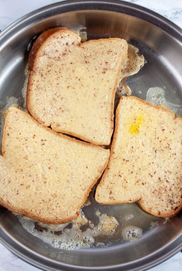 Uncooked French toast in skillet.