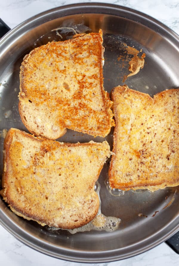 Cooked French toast in skillet.