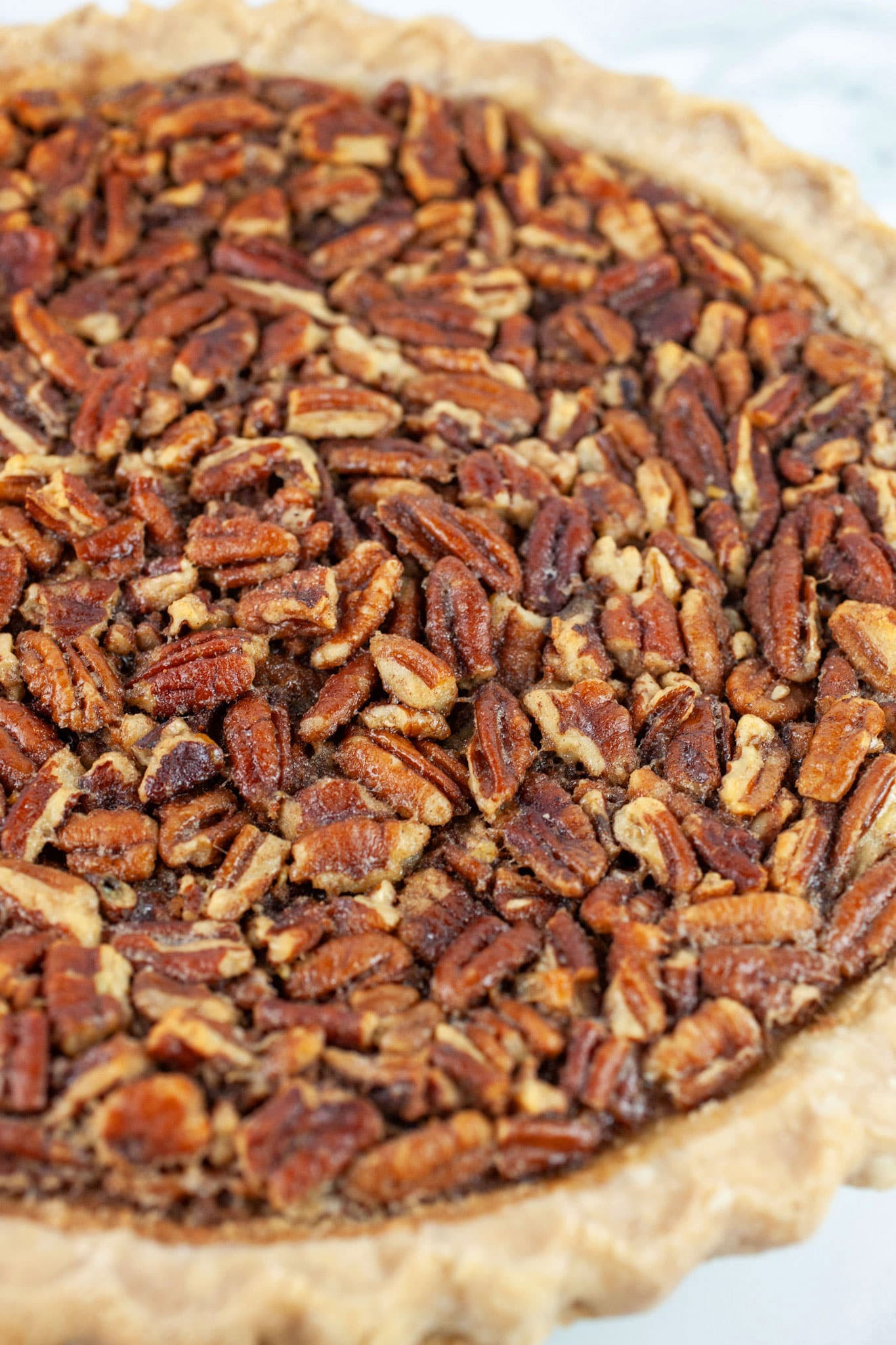 Baked maple bourbon pecan pie in dish.