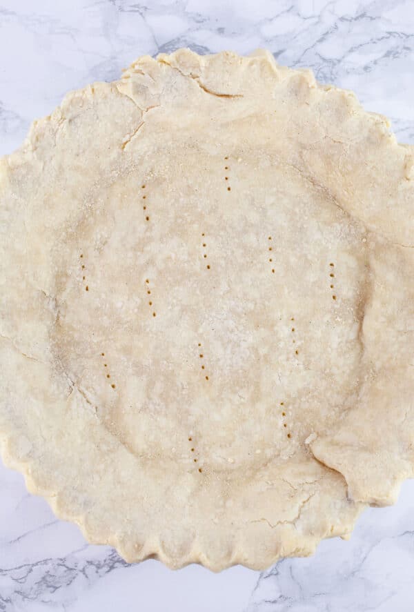 Parbaked gluten free pie crust in pie plate.