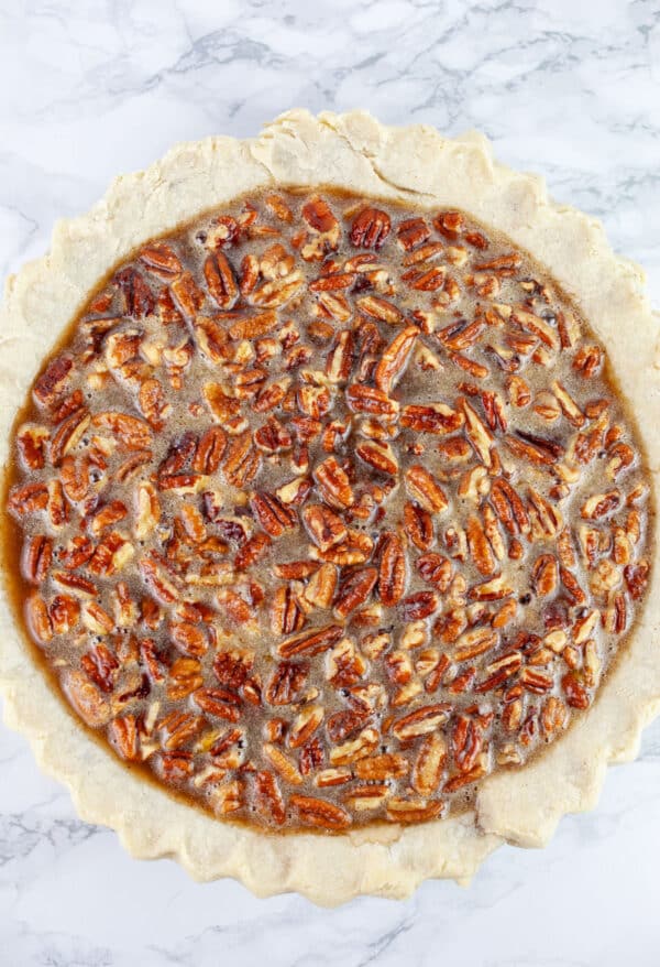 Unbaked maple pecan pie in pie pan.