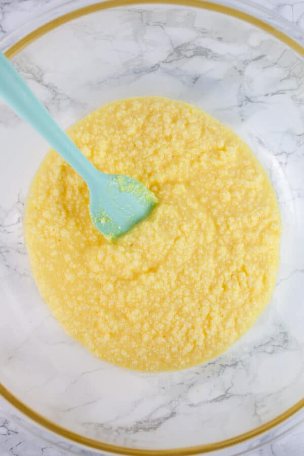 Wet ingredients in glass bowl with spatula.