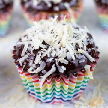 Coconut chocolate chip cupcakes with toasted coconut in colorful wrappers.