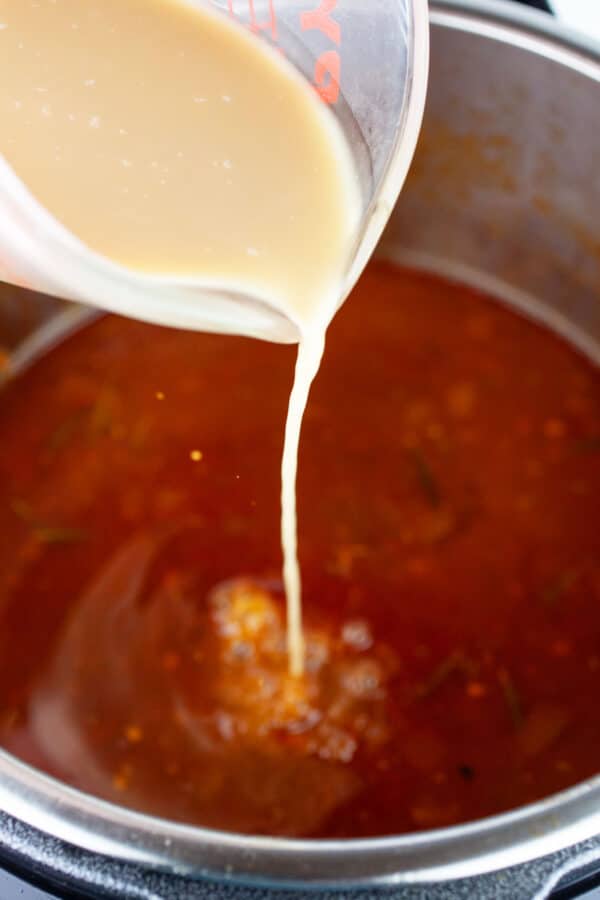 Corn starch slurry poured into Instant Pot with gravy.