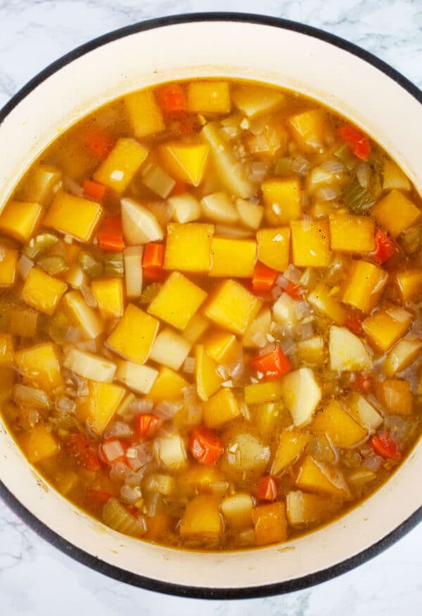 Cooked vegetable soup in Dutch oven.