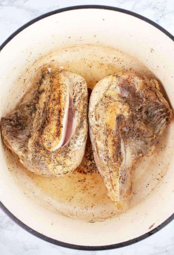 Split chicken breasts sauteed in Dutch oven.