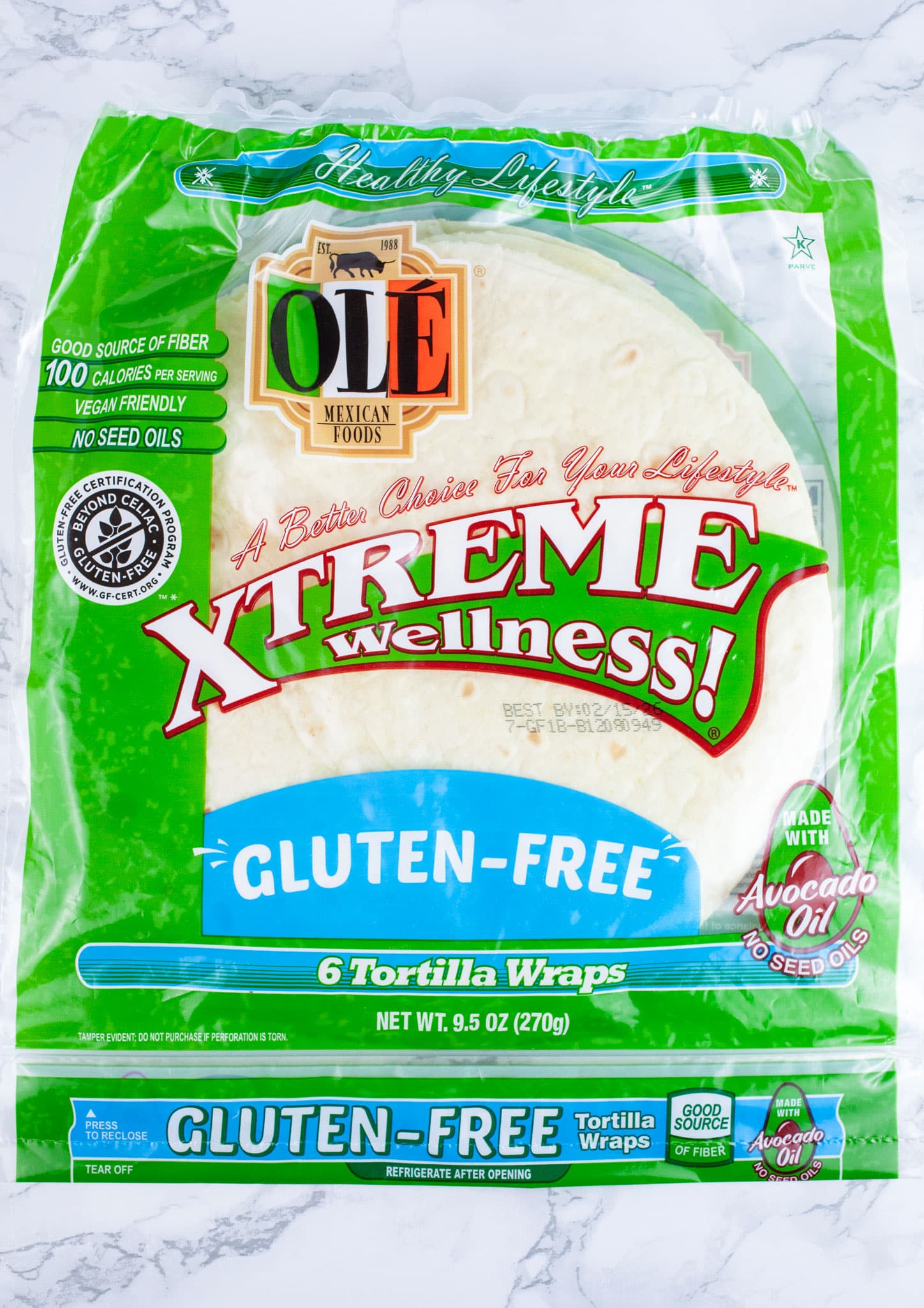 Package of gluten free tortilla wraps on white surface.