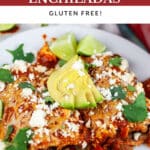 Ground beef enchiladas garnished with queso fresco, avocado, cilantro, and lime wedges on white plate with fork.