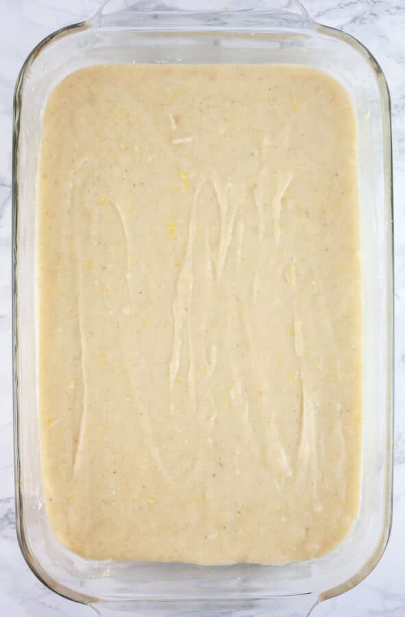 Cake batter in glass cake pan.