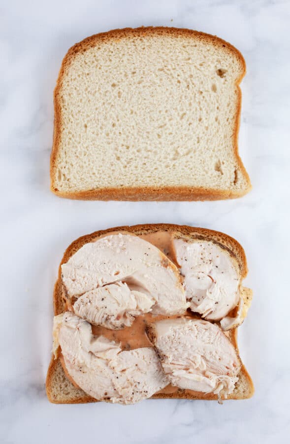 Sliced bread with chipotle mayo and roasted chicken.