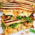 Chipotle chicken panini sandwich cut in half and stacked on itself.