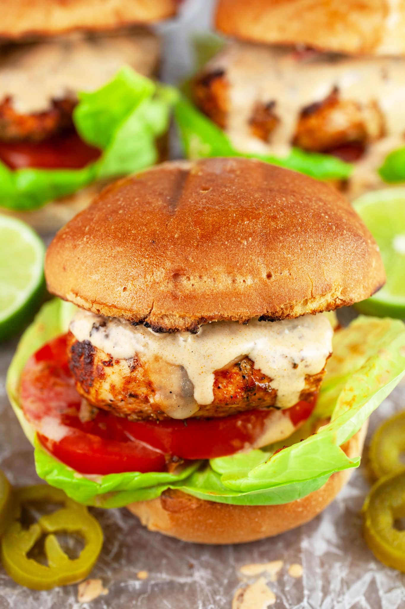 Chipotle chicken sandwiches with lettuce, tomato, and sauce.