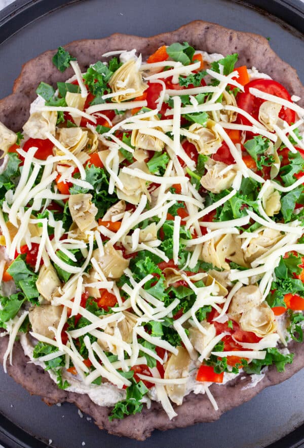 Unbaked Farmers Market Pizza on pizza pan.