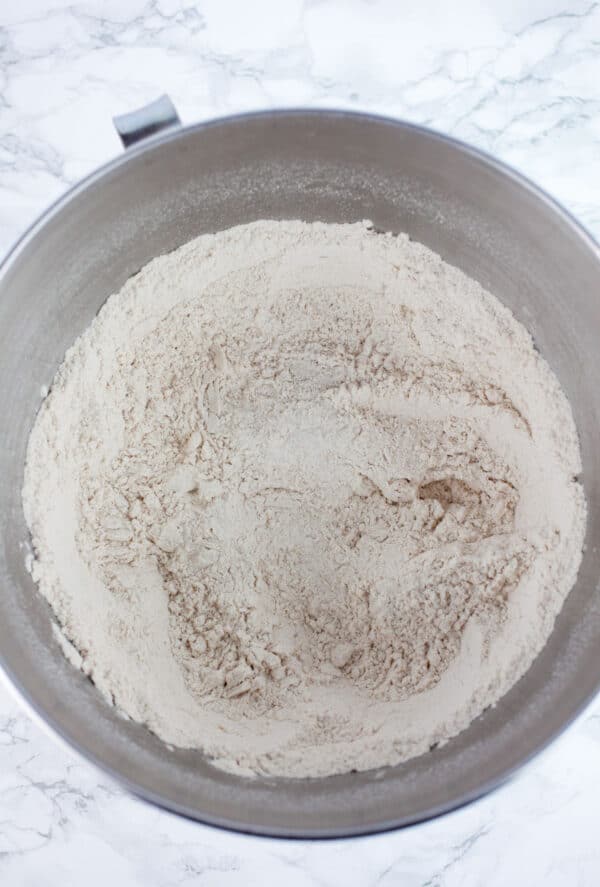 Dry pizza dough ingredients in large metal bowl.